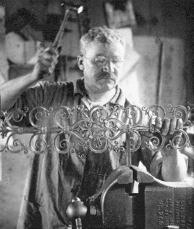 At work in the metal shop, where the utilitarian strength of steel sets off the exquisite lines of the ornamental hinge.